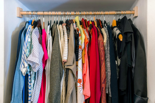 Wardrobe full of different color, material and texture clothes,