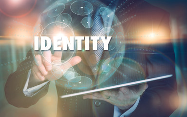 A hand selecting a Identity business concept on a futuristic computer display.