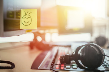 Feedback and motivation concept: Smiley Illustration at the working place, radio studio
