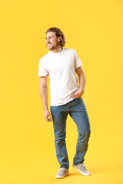 Stylish Young Man In Jeans On Color Background