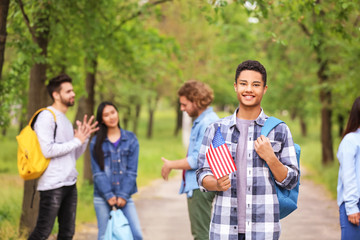 African-American student with USA flag outdoors