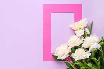 Beautiful peony flowers and frame on color background