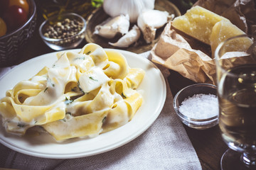 Traditional Italian Alfredo Pasta Plate with Creamy Cheese and Basil Sauce