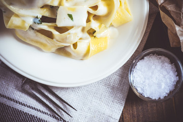 Traditional Italian Alfredo Pasta Plate with Creamy Cheese and Basil Sauce