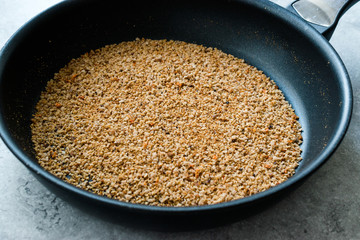 Pile of Bread Crumbs Frying in Pan
