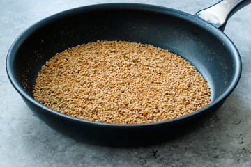 Pile of Bread Crumbs Frying in Pan
