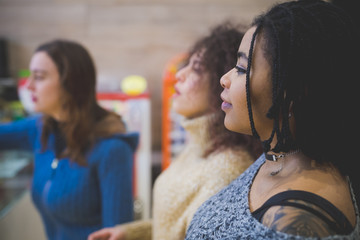 young multiracial women sitting together and having conversation