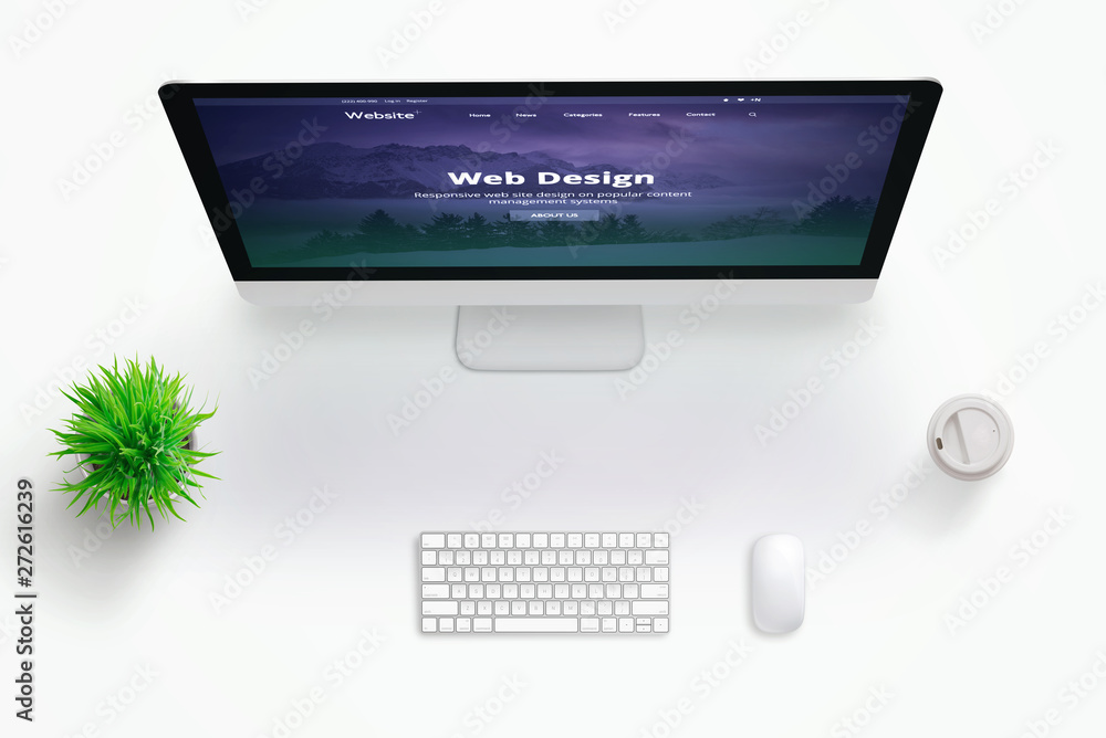 Poster Web design studio desk with monitor and web site presentation. Copy space in the middle for text. Flat lay.