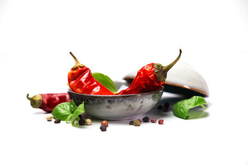 chilli pepper and basil leaves still life isolated on white backgroun