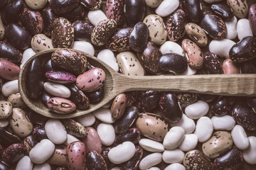 Organic Beans and Rustic Wooden Spoon on Dark Background