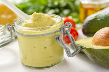 Vegan Raw and Healthy Fresh Food Concept. Organic Green Avocado Spread Guacamole in Jar.