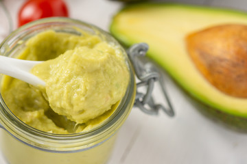 Vegan Raw and Healthy Fresh Food Concept. Organic Green Avocado Spread Guacamole in Jar.