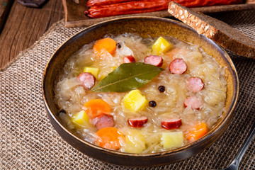 rustic sauerkraut soup with bacon and sausage