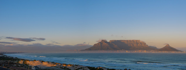 Table Bay, Cape Town, Table Mountain, Devil's Peak and Lion's Head from Blouberg at sunrise. Cape Town . Western Cape. South Africa