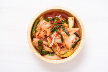 Kimchi cabbage in a bowl on white background, Korean food, top view