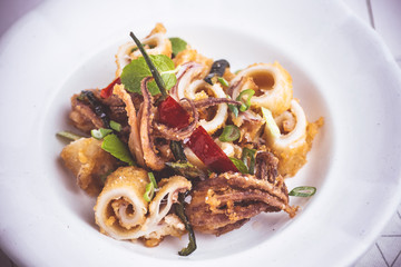 Fried Squid Calamari with Chili Pepper in Rustic White Plate