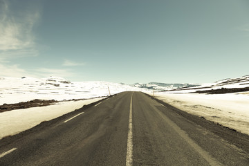 Asphalt road in the fjords of Iceland. Toned