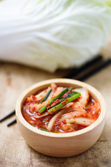 Kimchi cabbage in a bowl with chopsticks, Korean food