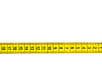 yellow tailor belt for waist measurement, measure lying on the table, close-up, empty space