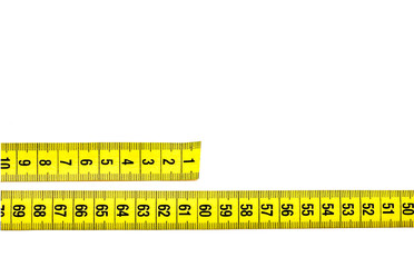 yellow tailor belt for waist measurement, measure lying on the table, close-up, empty space