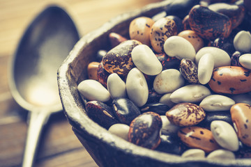 Colorful Beans and Wooden Spoon on Rustic Dark Background
