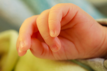 Little newborn baby hand closeup
