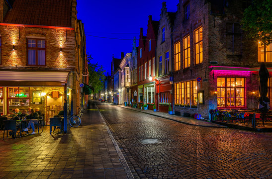 Old street of the historic city center of Bruges (Brugge), West Flanders province, Belgium. Night cityscape of Bruges.