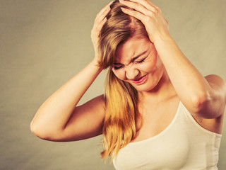 Woman suffering from headache migraine pain.