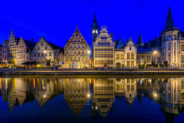 View of Graslei quay and Leie river in the historic city center in Ghent (Gent), Belgium. Architecture and landmark of Ghent. Night cityscape of Ghent.