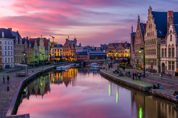 View of Graslei, Korenlei quays and Leie river in the historic city center in Ghent (Gent), Belgium. Architecture and landmark of Ghent. Sunset cityscape of Ghent.