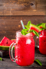 Cold summer drink. Homemade watermelon smoothie. Old wooden background copy space
