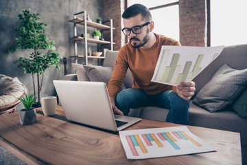 Portrait of handsome stylish trendy use user hold hand funds enterprise accountant have task strategy startup dressed eyewear eyeglasses denim jeans orange sweater pullover 