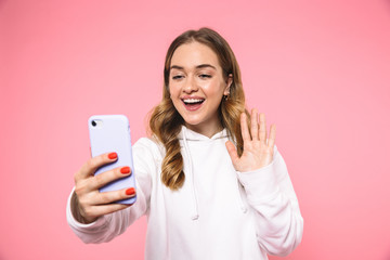 Fototapeta premium Happy blonde woman wearing in casual clothes talking by videocall