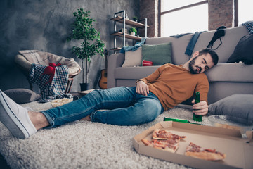 Obraz premium Portrait of sleepy funny funky post-graduate student lying had feast festival birthday anniversary close eyes denim jeans orange pullover sweater hold hand big light apartment