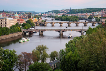 Obraz premium Prague bridges over Vltava River at dusk. Scenic view from Letna Hill, Czech Republic