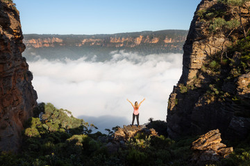 Woman feelings of exhilaration hiking in Blue Mountains Australia