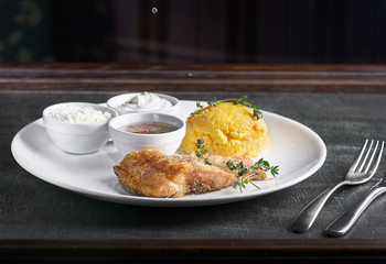 Fried fish steak carp served with Hominy on a white plate, to the Georgian recipe. Mediterranean Kitchen. Restaurant menu. Free space for text.