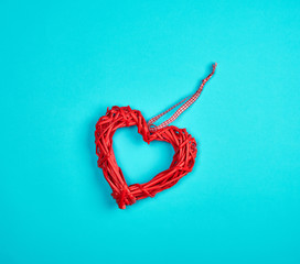 wicker red heart on a blue background, copy space