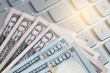 Dollar banknote on a laptop. Earned money by working from laptop at home.Freelance work making money concept