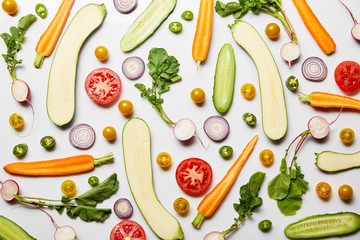 top view of fresh sliced organic vegetables on white background