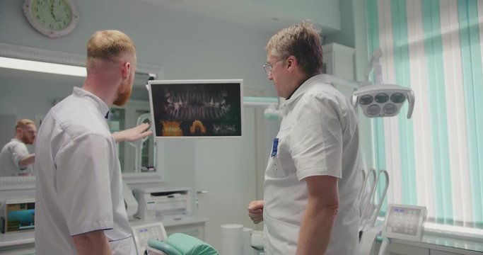 Two dentist doctors looking at x-ray