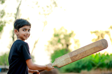 Rural Indian Child Playing Cricket