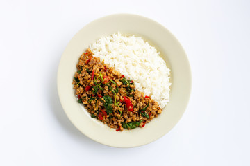 Rice with stir-fried hot and spicy pork with basil on white.