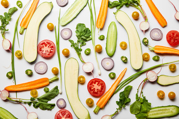 top view of fresh sliced nutritious vegetables on white background