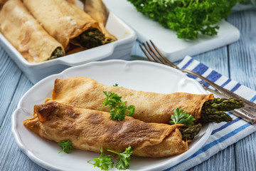 Asparagus and ham stuffed pancakes, baked on oven.