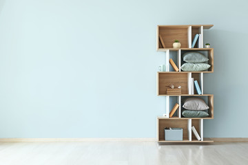 Modern shelf unit near color wall