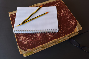 Vintage folio with a blank notepad and pencils