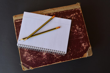 Vintage folio with a blank notepad and pencils