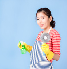 Asian beautiful woman holding a bottle spray  to clean the device and smiling happily to clean the house