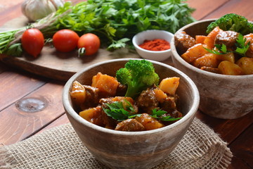 Traditional homemade Hungarian beef meat stew, Goulash with potatoes, carrots , tomatoes, broccoli in a bowl